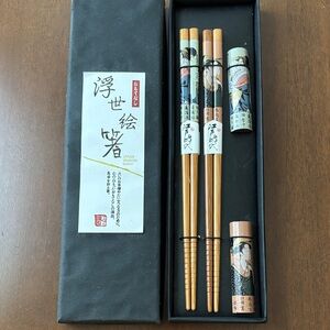 Japanese chopstick set with a geisha design. Includes holder/rest.